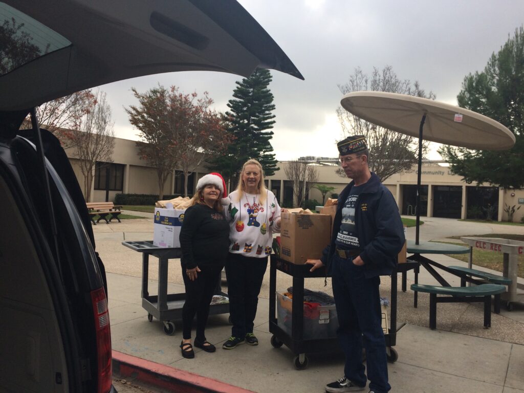 Auxiliary & VFW members unloadng the gift bags to cart