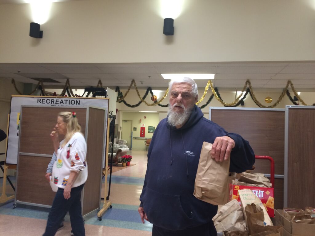 VFW Post 9934 Dana Point member Raymond Kuehl handing out gift bags